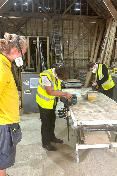School visit with children working with bench-mounted routers