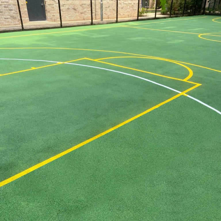 Multi-use game area with green and yellow ground markings.